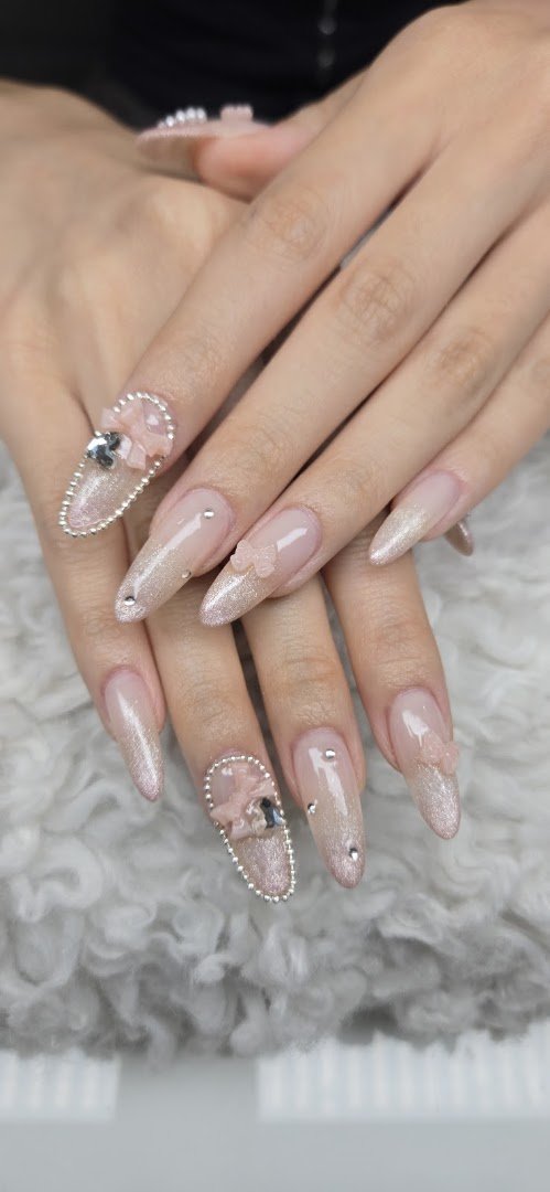 Manicured hands showing glossy nail designs.